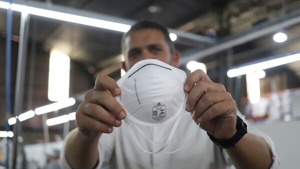 Julio Molezine, director of the Delta Plus plant holds a PFF2 respirator mask in Socorro, Sao Paulo state, Brazil March 3, 2020. Picture taken March 3, 2020 - Sputnik International