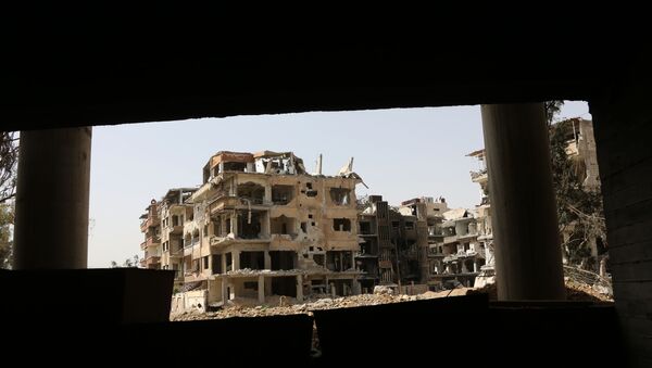 A general view shows destroyed buildings in the former rebel-held Syrian town of Douma on the outskirts of Damascus on April 19, 2018 - Sputnik International
