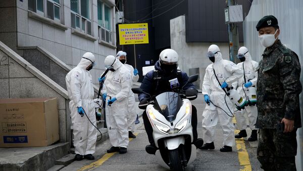 South Korean soldiers in protective gear sanitize a street at a shopping district in Seoul, South Korea, March 6, 2020 - Sputnik International