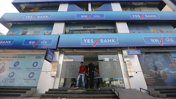 An Indian man walks out of a Yes Bank building in Ahmadabad, India - Sputnik International