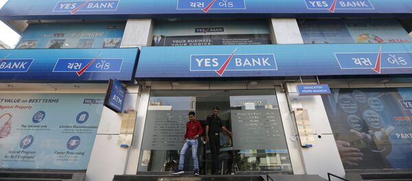An Indian man walks out of a Yes Bank building in Ahmadabad, India - Sputnik International