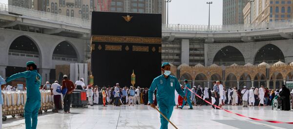 Cleaners wear protective face masks, following the outbreak of the coronavirus, as they swipe the floor at the Kaaba in the Grand mosque in the holy city of Mecca, Saudi Arabia 3 March 2020. Cleaners wear protective face masks, following the outbreak of the coronavirus, as they swipe the floor at the Kaaba in the Grand mosque in the holy city of Mecca, Saudi Arabia 3 March 2020. - Sputnik International