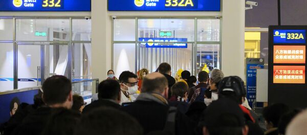 In this 2 February 2020 file photo, evacuees board an evacuation flight for EU nationals at Wuhan Tianhe International Airport in Wuhan in central China's Hubei Province. Arek and Jenina Rataj were starting a new life in the Chinese industrial centre of Wuhan when a viral outbreak spread across the city of 11 million. While they were relatively safe sheltering at home, Arek felt compelled to go out and document the outbreak of the new type of coronavirus. Among his subjects: the construction of a new hospital built in a handful of days; biosecurity check points; and empty streets. - Sputnik International