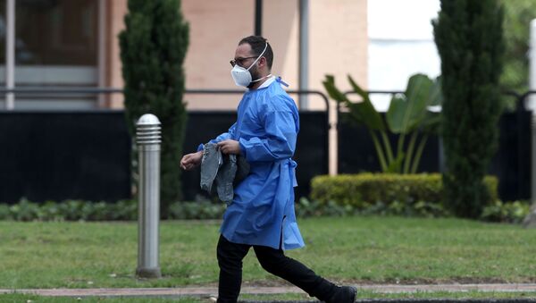 A man wearing face mask walks outside a sports centre in Bogota, Colombia February 28, 2020 - Sputnik International