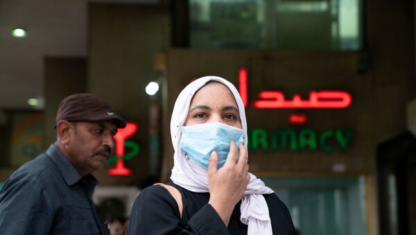 A woman wears a protective face mask, following the outbreak of the new coronavirus, in Kuwait, February 25, 2020 - Sputnik International