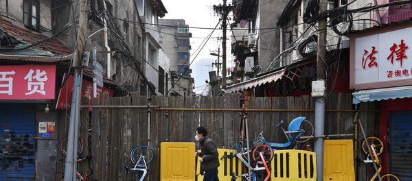 A man wearing a face mask runs past a street blocked by barricades and shared bicycles in Wuhan, the epicentre of the novel coronavirus outbreak, Hubei province, China March 5, 2020 A man wearing a face mask runs past a street blocked by barricades and shared bicycles in Wuhan, the epicentre of the novel coronavirus outbreak, Hubei province, China March 5, 2020 - Sputnik International