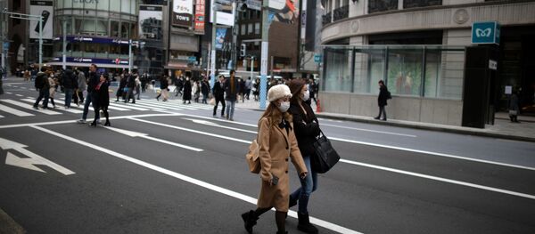 Women, wearing protective face masks walk in Tokyo Women, wearing protective face masks walk in Tokyo - Sputnik International