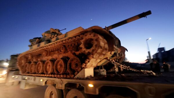 Turkish military vehicles enter the Bab al-Hawa crossing at the Syrian-Turkish border, in Idlib governorate, Syria, February 9, 2020. - Sputnik International