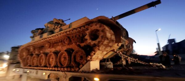 Turkish military vehicles enter the Bab al-Hawa crossing at the Syrian-Turkish border, in Idlib governorate, Syria, February 9, 2020. - Sputnik International