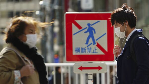 Pedestrians with protective masks on a street Thursday, 5 March 2020, in Tokyo. The number of infections of the COVID-19 disease spread around the globe. - Sputnik International