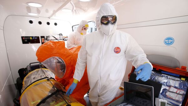 A doctor and paramedics from the Emergency Medical Care System (SAMU) of Jalisco stand inside the mobile intensive care medical unit the “UTIM”, the first in Latin America equipped to transfer people infected with the COVID-19 virus in Guadalajara, Jalisco state, Mexico on March 2, 2020. - Sputnik International
