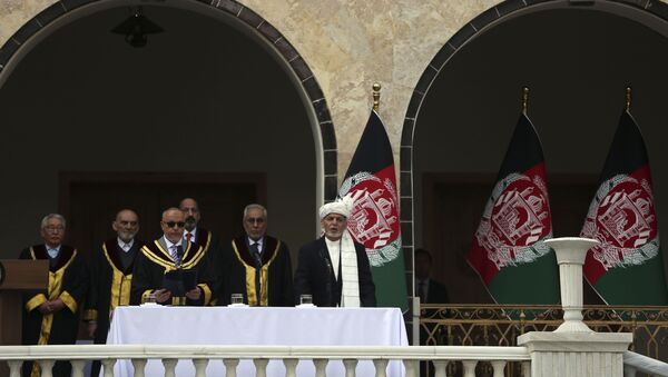 Afghan President Ashraf Ghani, right, is sworn in by Chief Justice Sayed Yousuf Halim, during his inauguration ceremony at the presidential palace in Kabul, Afghanistan, Monday, March 9, 2020 - Sputnik International
