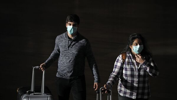 Passengers wear masks to help protect against coronavirus, at the Ben Gurion Airport near Tel Aviv, Israel, Sunday, March 8, 2020. - Sputnik International