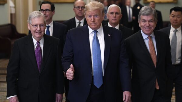 President Donald Trump gives a thumbs up as he walks with Senate Majority Leader Mitch McConnell of Ky., left, Treasury Secretary Steven Mnuchin, second from left, Vice President Mike Pence, and Sen. Roy Blunt, R-Mo., right, on Capitol Hill in Washington, Tuesday, March 10, 2020. (AP Photo/Susan Walsh) - Sputnik International