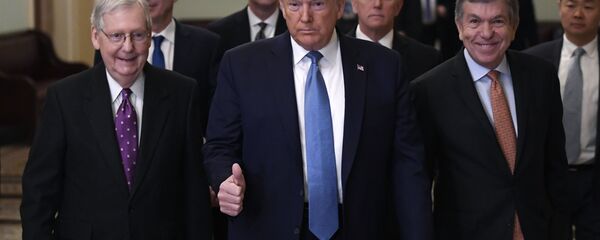 President Donald Trump gives a thumbs up as he walks with Senate Majority Leader Mitch McConnell of Ky., left, Treasury Secretary Steven Mnuchin, second from left, Vice President Mike Pence, and Sen. Roy Blunt, R-Mo., right, on Capitol Hill in Washington, Tuesday, March 10, 2020. (AP Photo/Susan Walsh) - Sputnik International