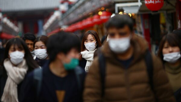 Tourists wearing protective face masks, following an outbreak of the coronavirus disease (COVID-19), visit Asakusa neighbourhood in Tokyo, Japan March 8, 2020 - Sputnik International