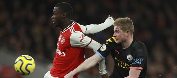 Arsenal's Nicolas Pepe, left, fights for the ball with Manchester City's Kevin De Bruyne during the English Premier League soccer match between Arsenal and Manchester City, at the Emirates Stadium in London, Sunday, Dec. 15, 2019. Arsenal's Nicolas Pepe, left, fights for the ball with Manchester City's Kevin De Bruyne during the English Premier League soccer match between Arsenal and Manchester City, at the Emirates Stadium in London, Sunday, Dec. 15, 2019. - Sputnik International