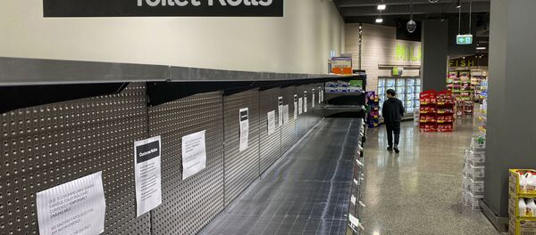 A shopper passes empty shelves usually stocked with toilet paper in a supermarket in Melbourne on March 5, 2020 A shopper passes empty shelves usually stocked with toilet paper in a supermarket in Melbourne on March 5, 2020 - Sputnik International