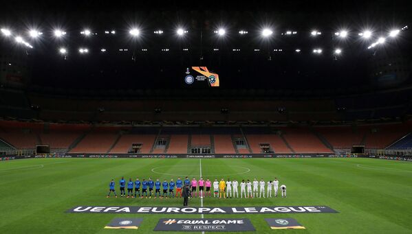 The teams line up before the match in an empty stadium after fans were not allowed in over coronavirus fears - Sputnik International