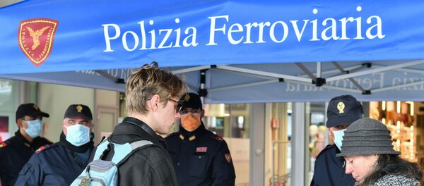 Police perform control checks on passengers at the Santa Lucia railway station in Venice on March 10, 2020, after Italy imposed unprecedented national restrictions on its 60 million people Tuesday to control the deadly COVID-19 coronavirus. - Sputnik International