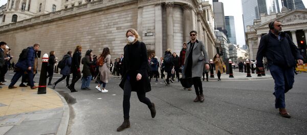 A woman wearing a protective face mask, following an outbreak of the coronavirus, walks in front of the Bank of England in London, Britain March 11, 2020 A woman wearing a protective face mask, following an outbreak of the coronavirus, walks in front of the Bank of England in London, Britain March 11, 2020 - Sputnik International