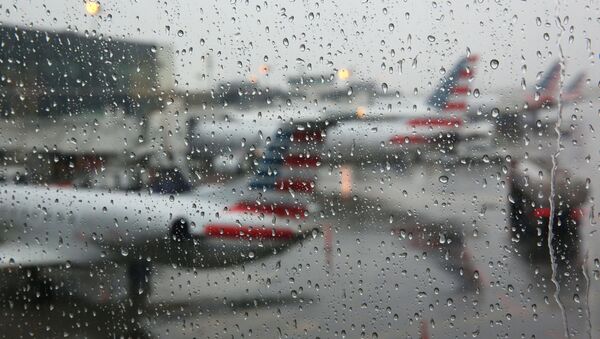 Airplanes are seen parked through a rain soaked window at their gates during a winter nor'easter at LaGuardia Airport in New York - Sputnik International