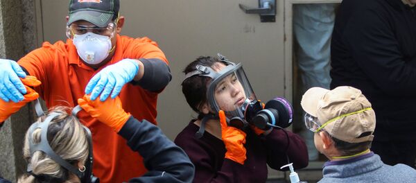 Members of a Servpro cleaning crew take off their protective gears as they exit the Life Care Center of Kirkland, the Seattle-area nursing home at the epicenter of one of the biggest coronavirus outbreaks in the United States, in Kirkland, Washington, U.S. March 11, 2020. - Sputnik International