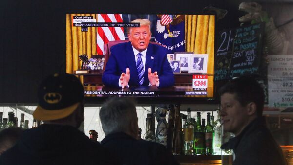 U.S. President Donald Trump's televised address to the nation is pictured in the bar at A Pizza Mart, in Seattle, Washington, U.S. March 11, 2020.   - Sputnik International
