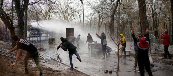 Greek riot police use a water cannon to disperse stone throwing migrants as they wait on the no man's land between Turkey and Greece, at Turkey's Pazarkule border crossing with Greece's Kastanies, in Edirne, Turkey, March 8, 2020.  - Sputnik International