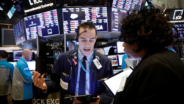 Traders work on the floor of the New York Stock Exchange (NYSE) near the close of trading in New York, U.S., March 12, 2020 - Sputnik International