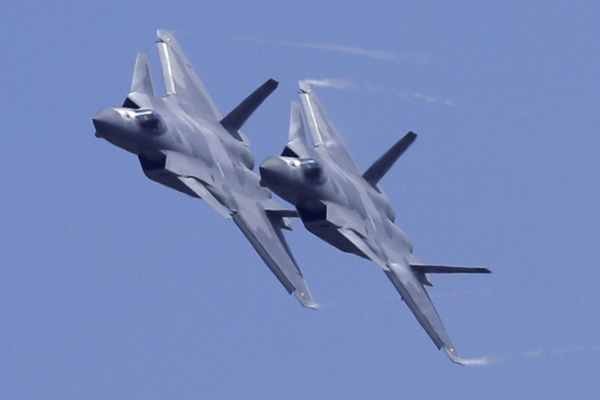 Two J-20 stealth fighter jets of the Chinese People's Liberation Army (PLA) Air Force performs during the 12th China International Aviation and Aerospace Exhibition, also known as Airshow China 2018, Tuesday, Nov. 6, 2018, in Zhuhai city, south China's Guangdong province - Sputnik International, 1920, 30.11.2022