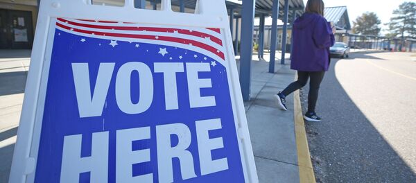 A Person Walks Past a Sign During a Runoff Election - Sputnik International