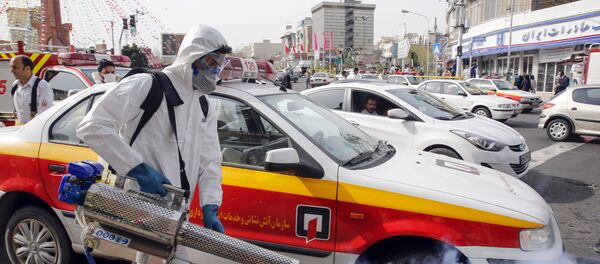 An Iranian firefighter disinfects a street in the capital Tehran in a bid to halt the wild spread of coronavirus on March 13 2020. - Iranian forces will clear the streets nationwide within 24 hours and all citizens will be checked for the new coronavirus in a bid to halt its spread, the military said An Iranian firefighter disinfects a street in the capital Tehran in a bid to halt the wild spread of coronavirus on March 13 2020. - Iranian forces will clear the streets nationwide within 24 hours and all citizens will be checked for the new coronavirus in a bid to halt its spread, the military said - Sputnik International