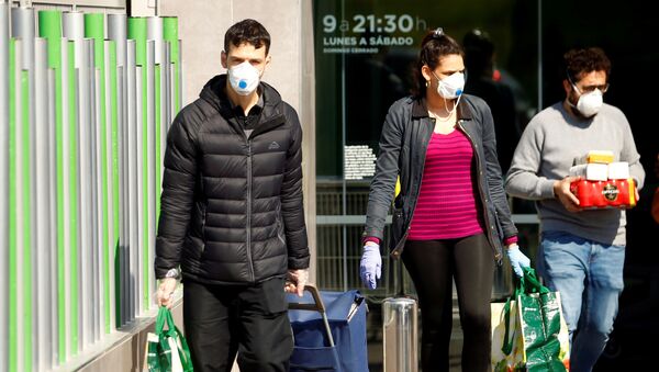 People wearing protective masks walk out of a supermarket, amidst concerns over Spain's coronavirus outbreak in central Madrid - Sputnik International