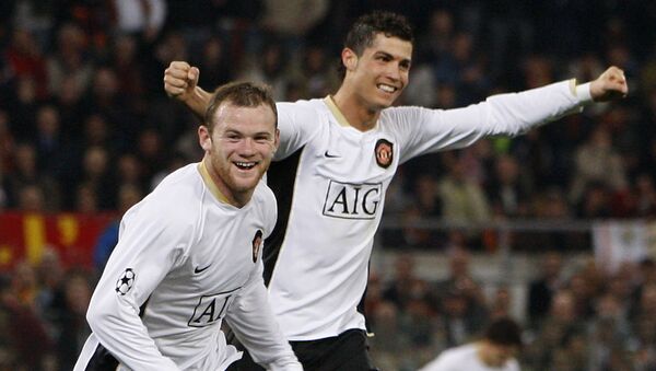 Manchester United's Wayne Rooney, left, celebrates after scoring  against AS Roma with teammate Cristiano Ronaldo, during their Champion's League quarterfinal, first-leg soccer match at the Rome Olympic stadium, Rome, Italy, Tuesday April 1, 2008. Manchester United won 2-0 with the first goal scored by Ronaldo and the second one by Rooney. - Sputnik International
