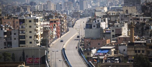 People walk on a highway that is almost empty of cars, east Beirut, Lebanon, Sunday, 15 March 2020. For most people, the new coronavirus causes only mild or moderate symptoms, such as fever and cough. For some, especially older adults and people with existing health problems, it can cause more severe illness, including pneumonia - Sputnik International
