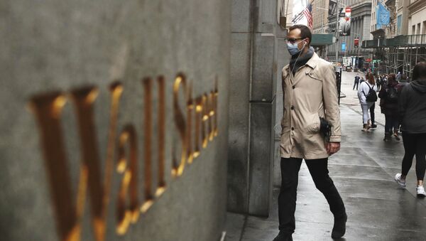 A man wears a protective mask as he walks on Wall Street during the coronavirus outbreak in New York City, New York, U.S., March 13, 2020 - Sputnik International