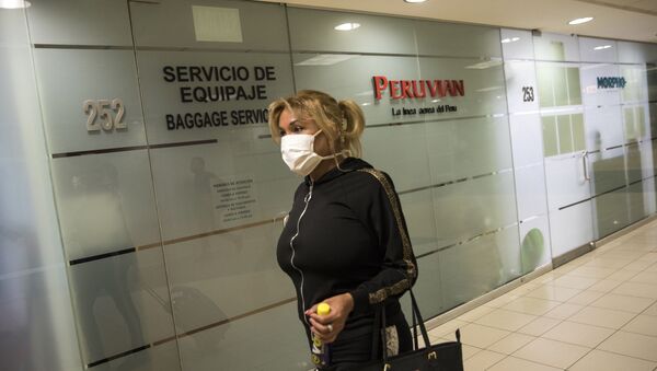 Protected with a mask, a passenger walks to the departure lounge at the international airport in Lima, Peru, Friday, 6 March 2020. On Friday, Peruvian President Martin Vizcarra announced the first case of the new coronavirus in the country - Sputnik International
