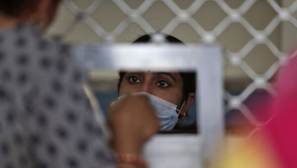 Indians wear masks inside Government Medical College hospital in Jammu, India, Monday, March 16, 2020. For most people, the new coronavirus causes only mild or moderate symptoms. For some, it can cause more severe illness, especially in older adults and people with existing health problems. - Sputnik International