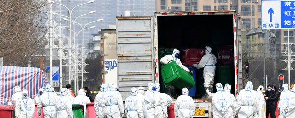 Workers in protective suits take part in the disinfection of Huanan seafood market, where the novel coronavirus is believed to have first surfaced, in Wuhan, Hubei province, China March 4, 2020. cnsphoto via REUTERS.  - Sputnik International