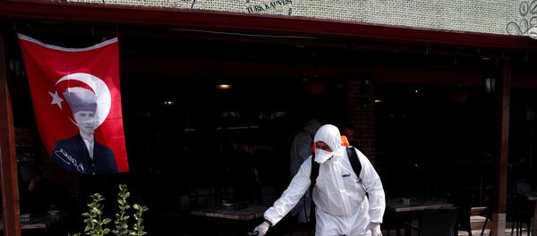 A municipality worker wearing protective suit sanitises a coffee shop in Karaagac district against the coronavirus disease (COVID-19) near Turkey's Pazarkule border crossing with Greece's Kastanies, in Edirne, Turkey, March 10, 2020 - Sputnik International