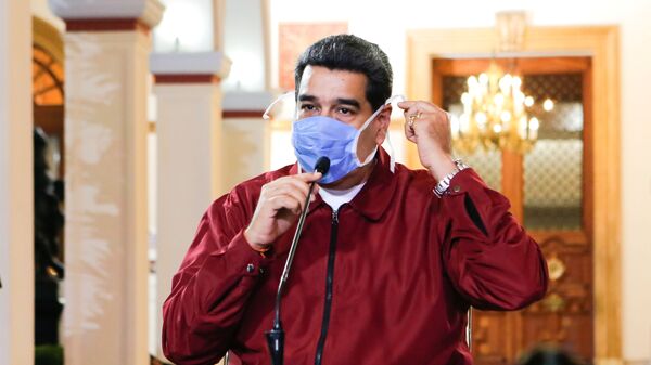 Venezuela's President Nicolas Maduro wears a protective face mask as he speaks during a meeting at Miraflores Palace in Caracas, Venezuela March 13, 2020 - Sputnik International