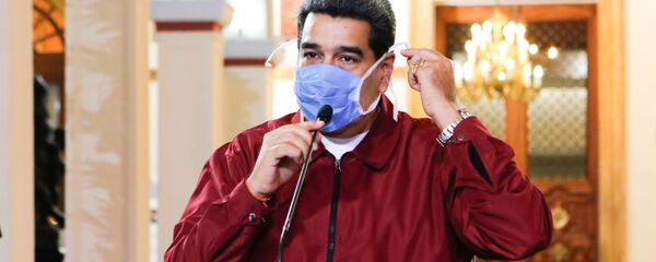 Venezuela's President Nicolas Maduro wears a protective face mask as he speaks during a meeting at Miraflores Palace in Caracas, Venezuela March 13, 2020 - Sputnik International