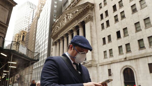 A man wears a protective mask as he walks past the New York Stock Exchange on the corner of Wall and Broad streets during the coronavirus outbreak in New York City, New York, U.S., March 13, 2020 - Sputnik International