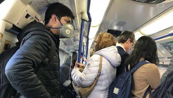 A man wears a mask on the London Underground amid the coronavirus outbreak - Sputnik International
