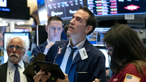 Trader Gregory Rowe, center, and others work on the floor of the New York Stock Exchange Monday, March 16, 2020.  - Sputnik International
