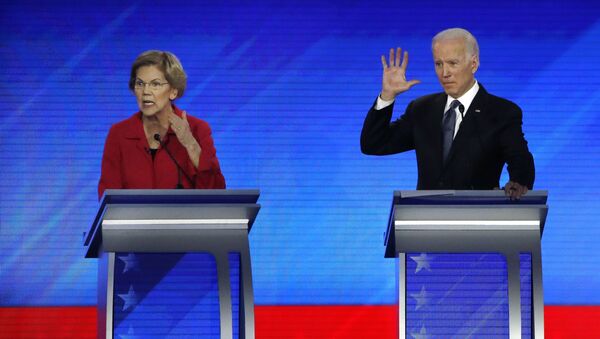 Democratic presidential candidate Sen. Elizabeth Warren, D-Mass., left, speaks as former Vice President Joe Biden waits during a Democratic presidential primary debate, Friday, Feb. 7, 2020, hosted by ABC News, Apple News, and WMUR-TV at Saint Anselm College in Manchester, N.H.  - Sputnik International