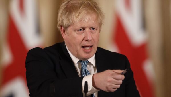 British Prime Minister Boris Johnson gestures as he gives a press conference about the ongoing situation with the COVID-19 coronavirus outbreak inside 10 Downing Street in London, Tuesday, March 17, 2020 - Sputnik International