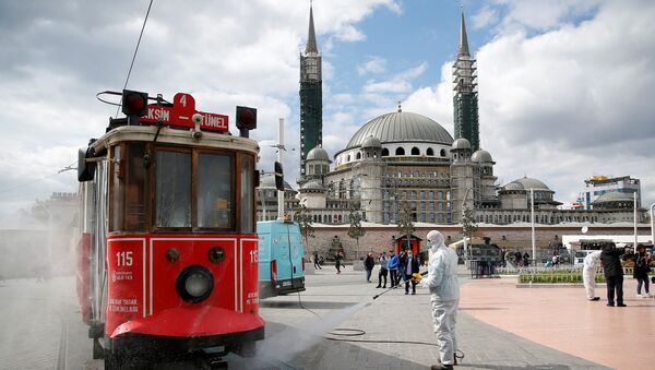 A municipality worker sprays disinfectant over a tram to prevent the spread of coronavirus disease (COVID-19) in central Istanbul, Turkey, March 18, 2020 - Sputnik International