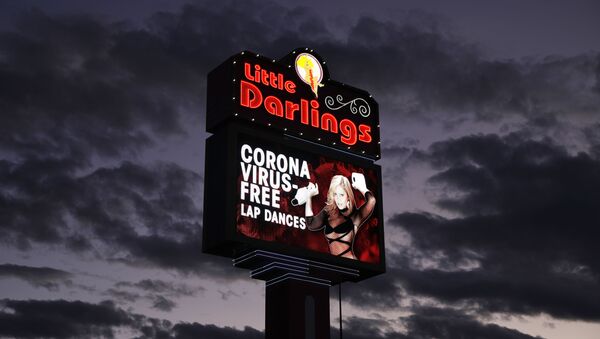 A sign at a strip club advertises coronavirus-free lap dances Friday, March 13, 2020, in Las Vegas - Sputnik International